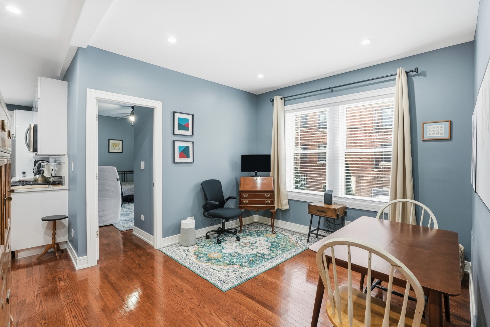2212 East 70th Street, Unit 1B Chicago, IL 60649 - Photo 13 of 20 a view of a dining room with furniture a chandelier and wooden floor