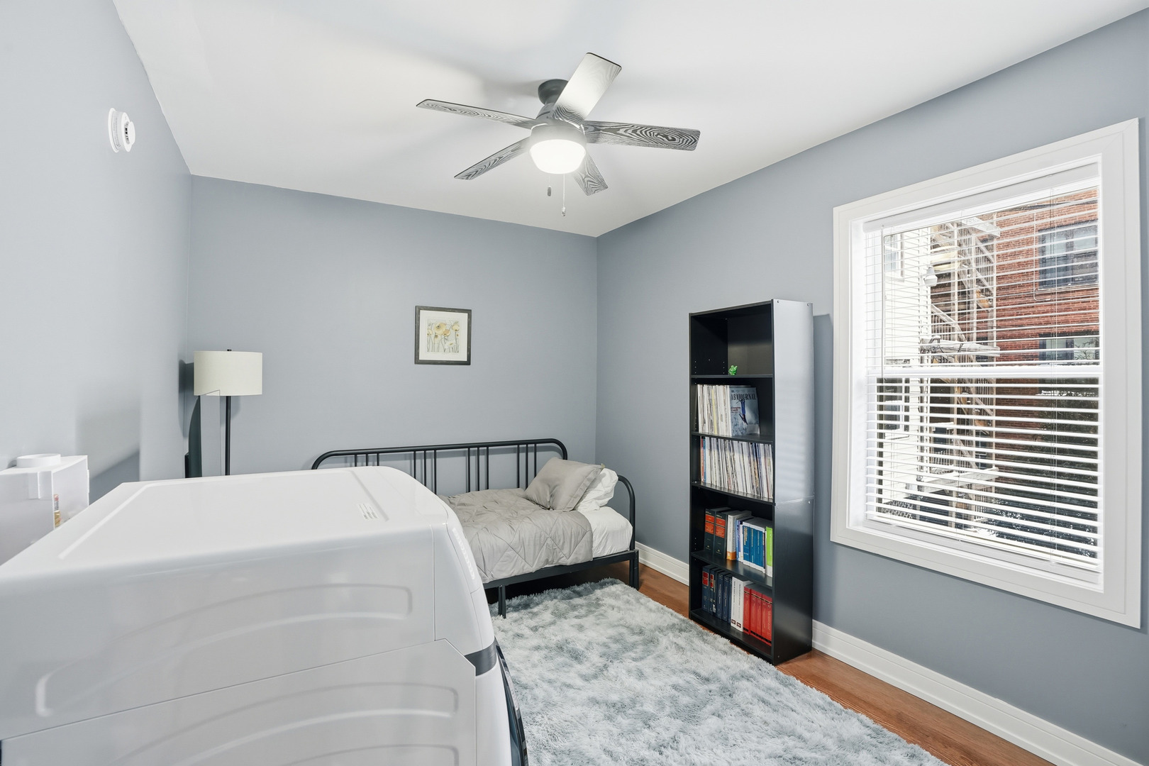 2212 East 70th Street, Unit 1B Chicago, IL 60649 - Photo 6 of 20 a bedroom with a large bed and a window