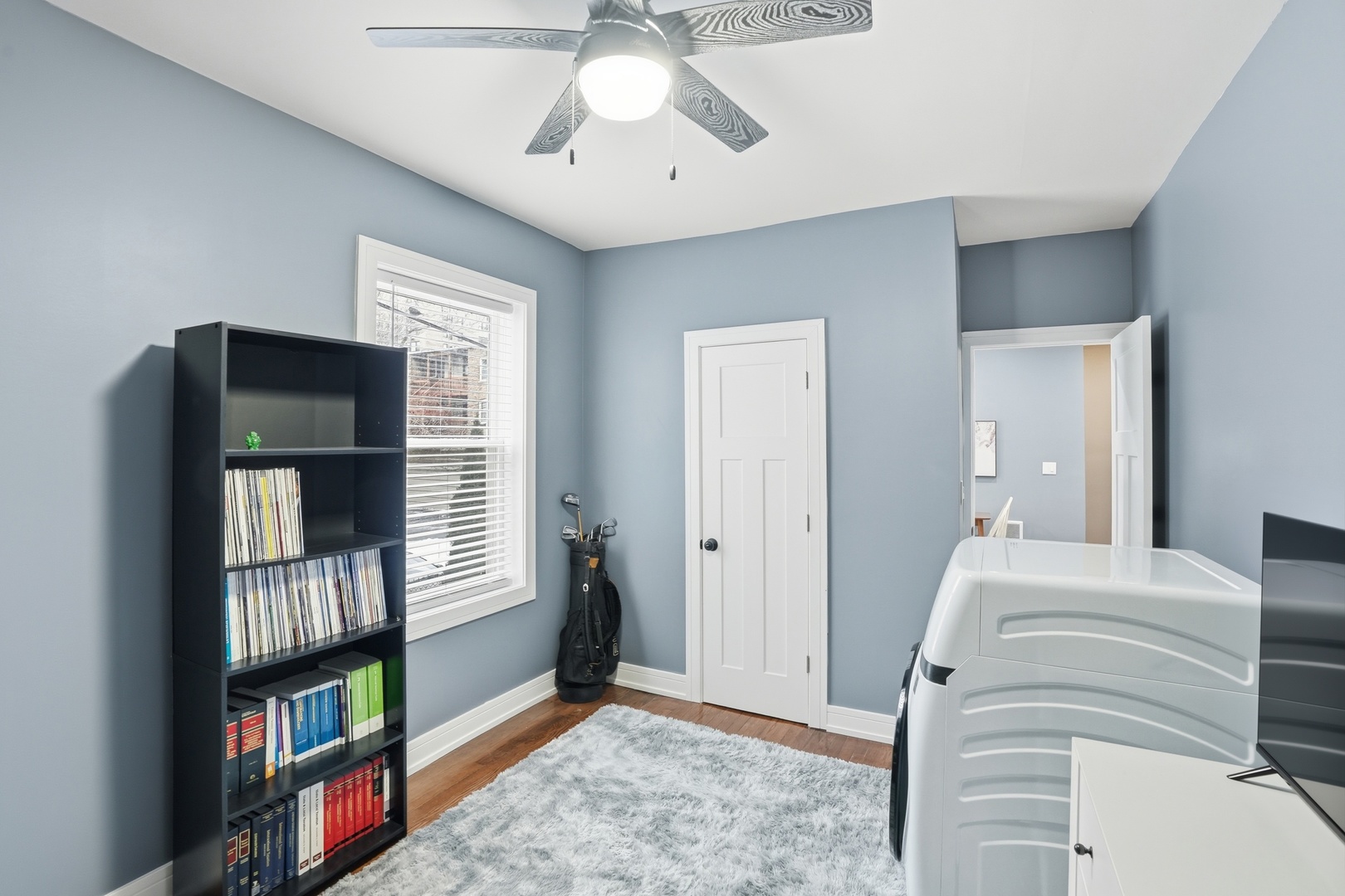 2212 East 70th Street, Unit 1B Chicago, IL 60649 - Photo 7 of 20 a bedroom with furniture and a book shelf