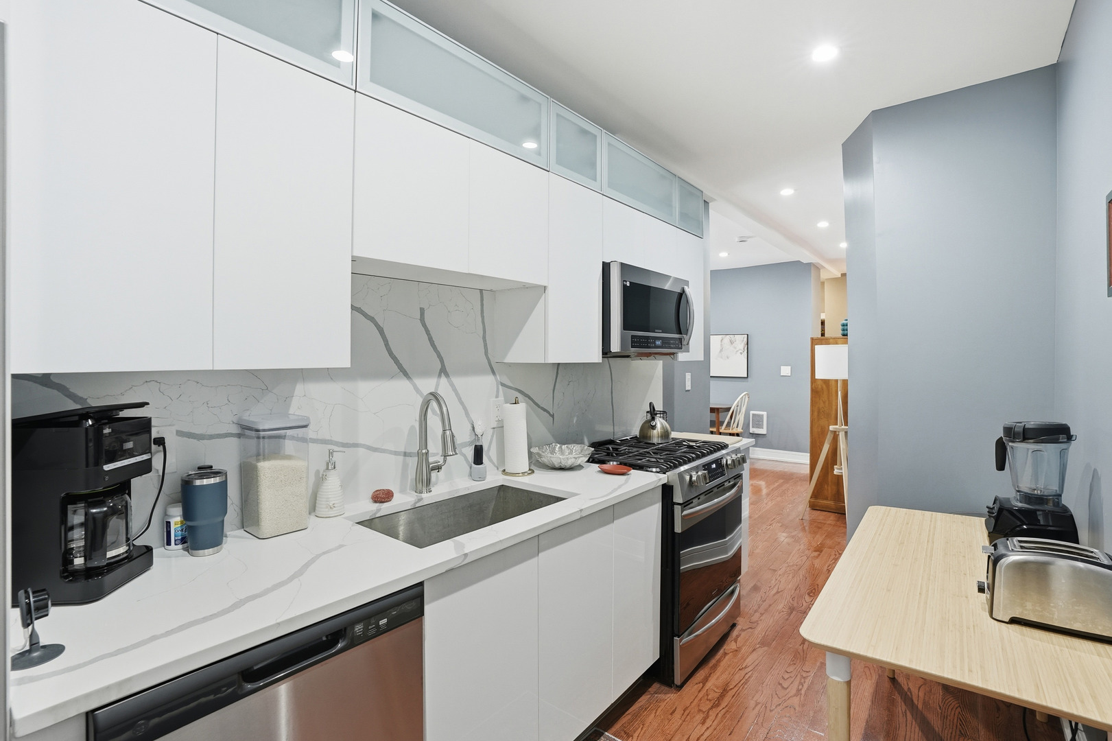 2212 East 70th Street, Unit 1B Chicago, IL 60649 - Photo 10 of 20 a kitchen that has a sink cabinets counter space and appliances