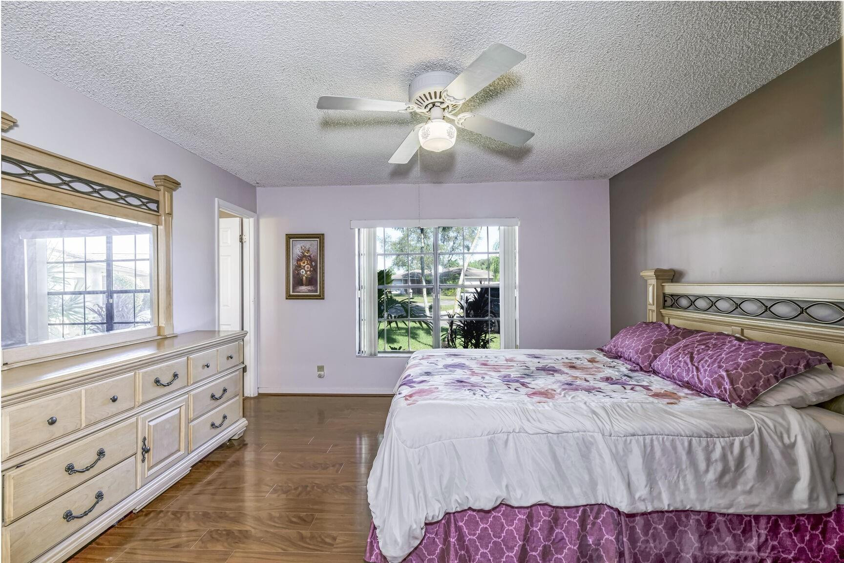 12630 Southwest 13th Manor Davie, FL 33325 - Photo 11 of 22 a bedroom with a large bed and a window