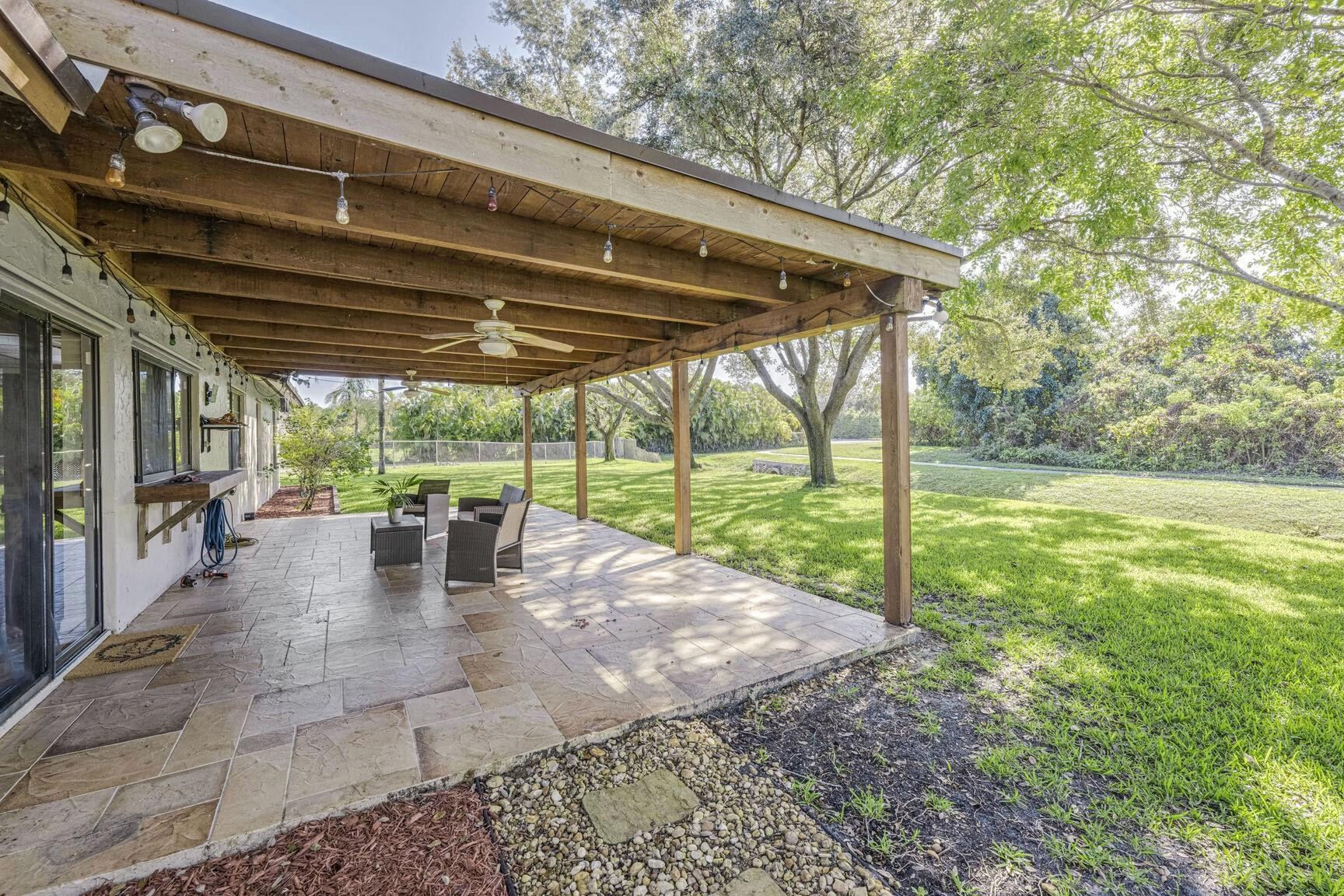 12630 Southwest 13th Manor Davie, FL 33325 - Photo 17 of 22 a view of a yard with porch and outdoor seating