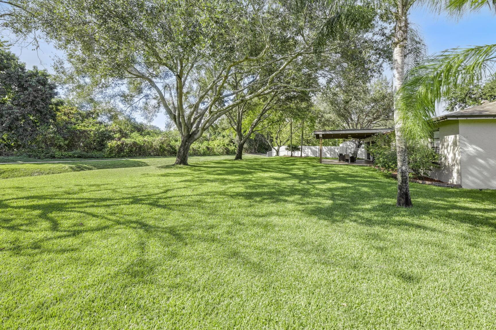 12630 Southwest 13th Manor Davie, FL 33325 - Photo 19 of 22 a backyard of a house with table and chairs