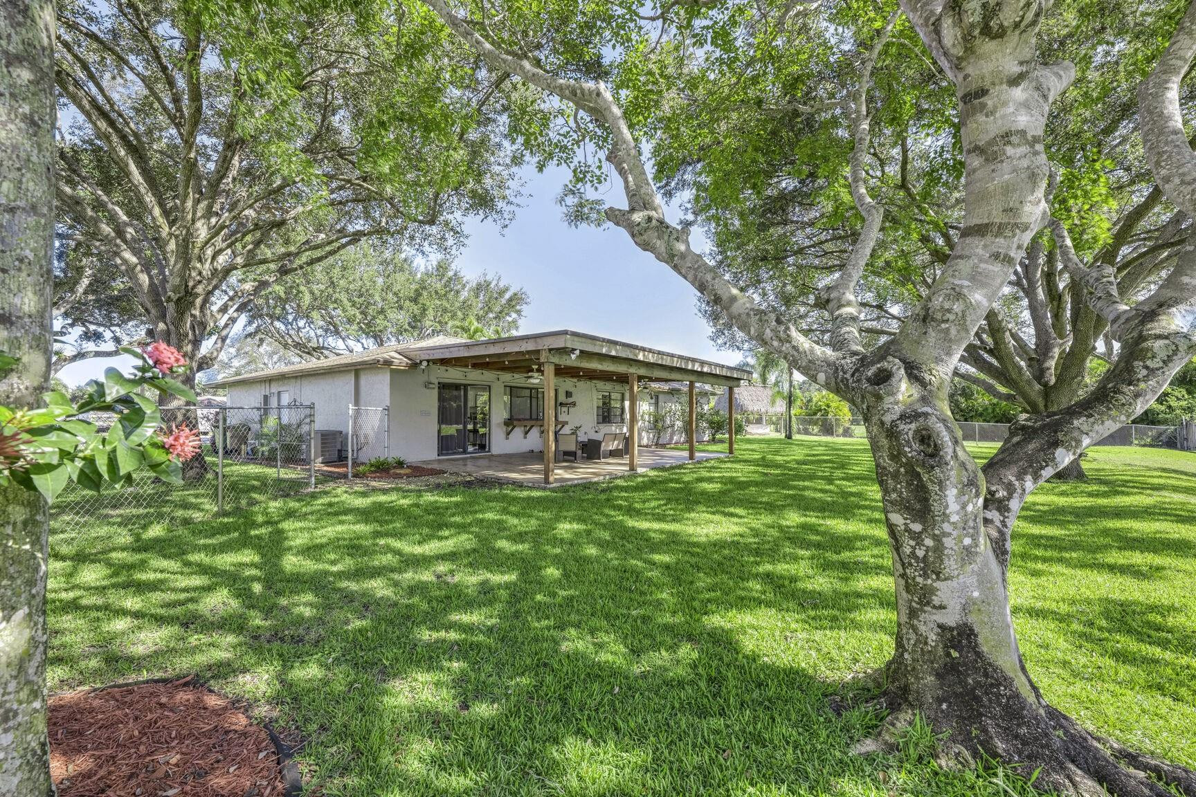 12630 Southwest 13th Manor Davie, FL 33325 - Photo 21 of 22 a front view of a house with garden