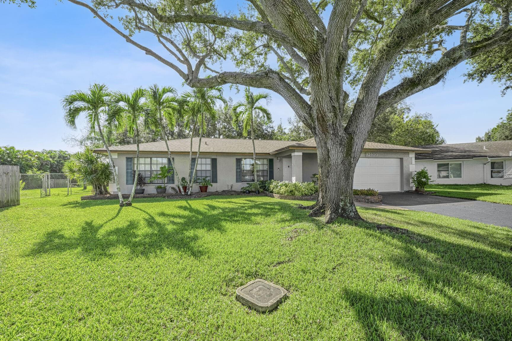 12630 Southwest 13th Manor Davie, FL 33325 - Photo 22 of 22 a view of a house with backyard and a tree
