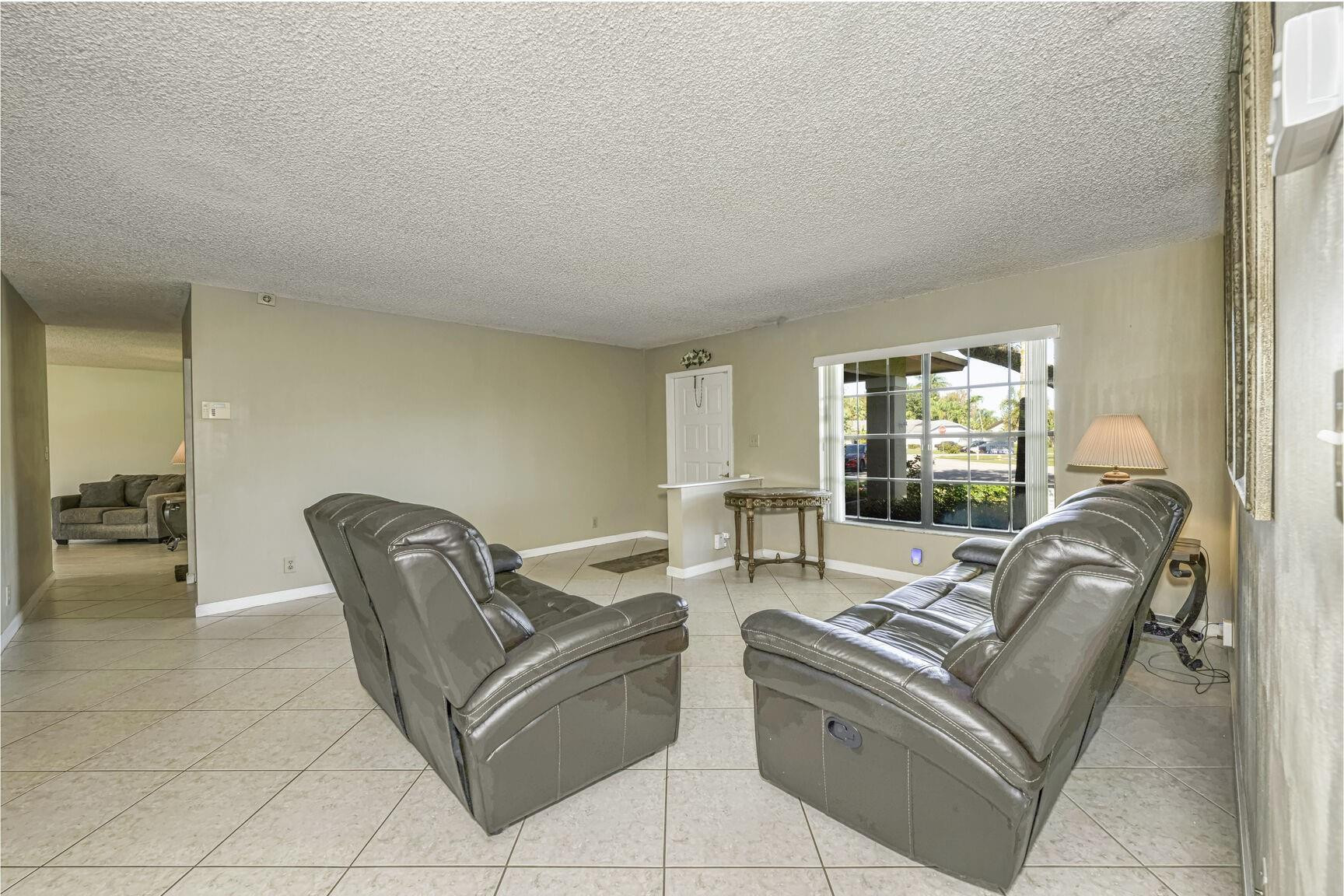 12630 Southwest 13th Manor Davie, FL 33325 - Photo 5 of 22 a living room with furniture and a potted plant