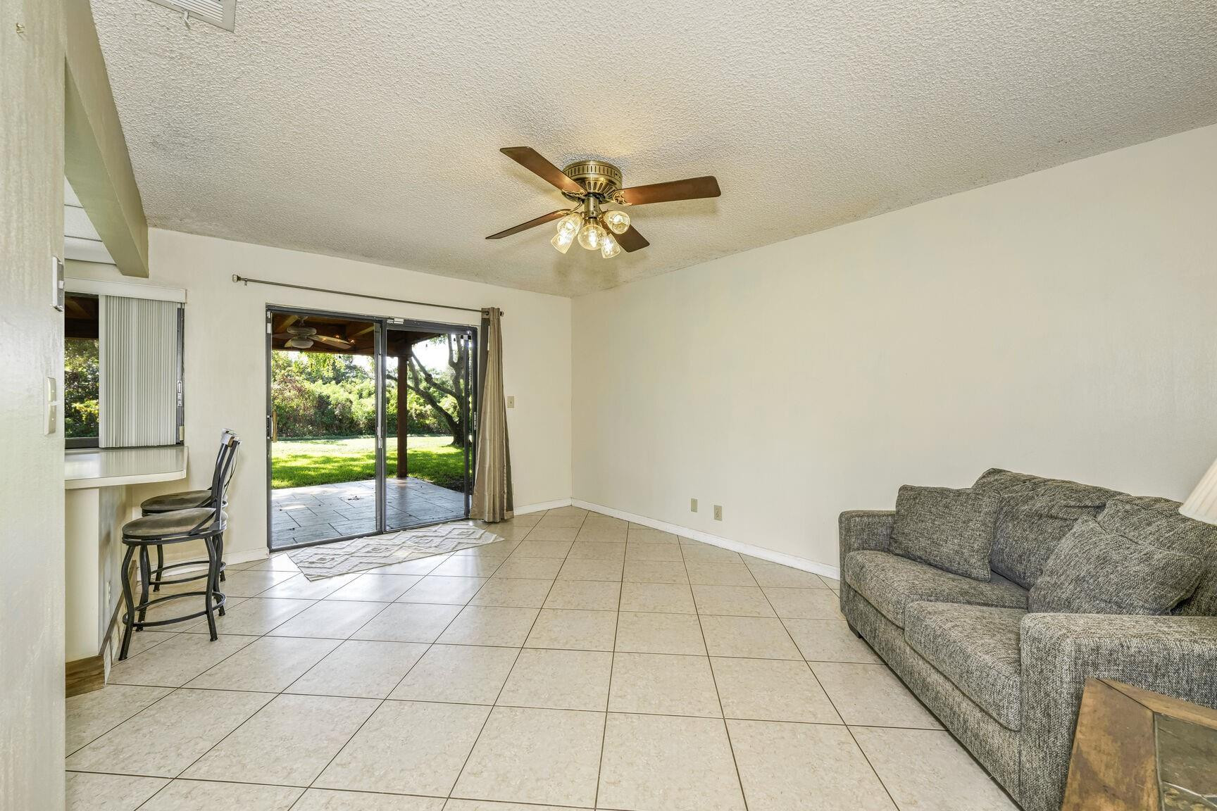 12630 Southwest 13th Manor Davie, FL 33325 - Photo 7 of 22 a living room with furniture and a floor to ceiling window