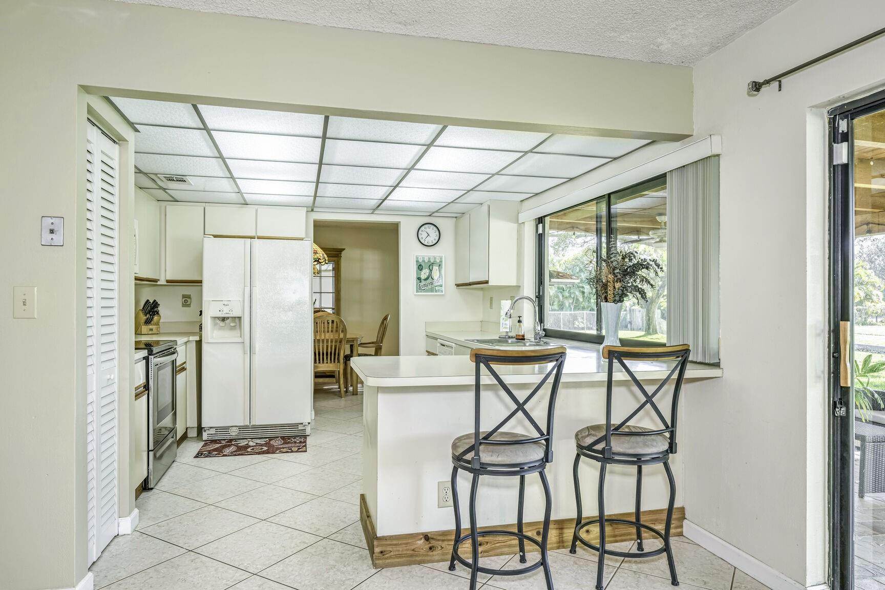 12630 Southwest 13th Manor Davie, FL 33325 - Photo 8 of 22 a view of a kitchen with furniture and a window