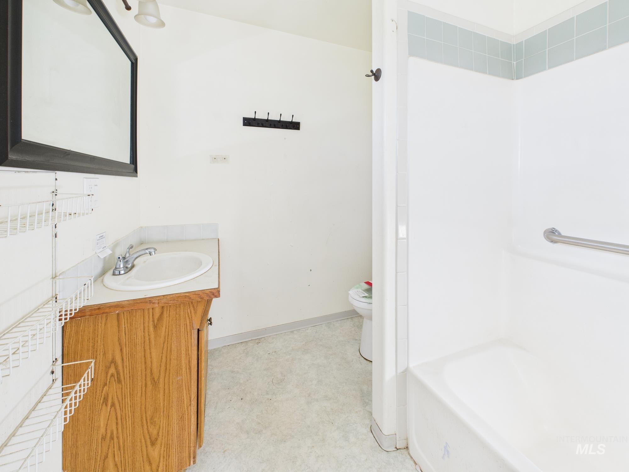 7352 Custer Road Fruitland, ID 83619 - Photo 16 of 43 Bathroom featuring vanity and washtub / shower combination