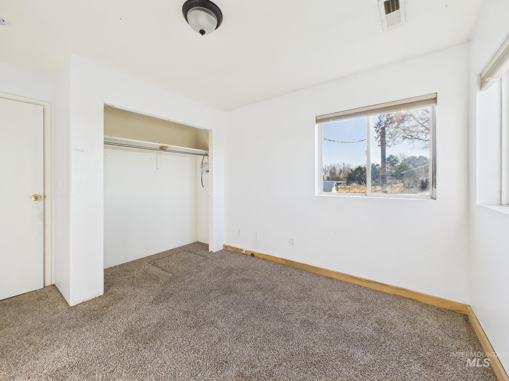 7352 Custer Road Fruitland, ID 83619 - Photo 21 of 43 Unfurnished bedroom featuring carpet and a closet