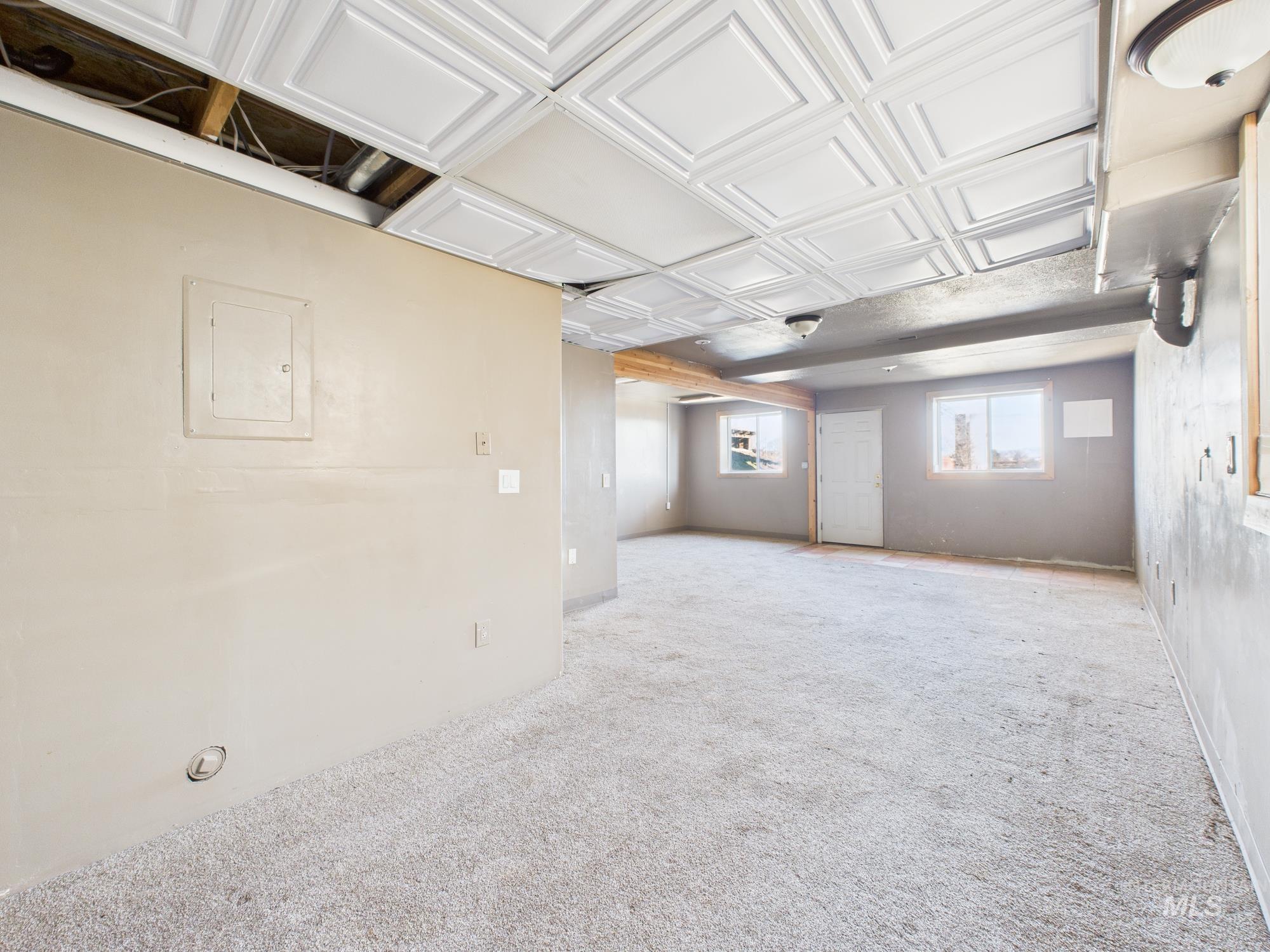 7352 Custer Road Fruitland, ID 83619 - Photo 22 of 43 Basement featuring carpet floors, electric panel, and an ornate ceiling