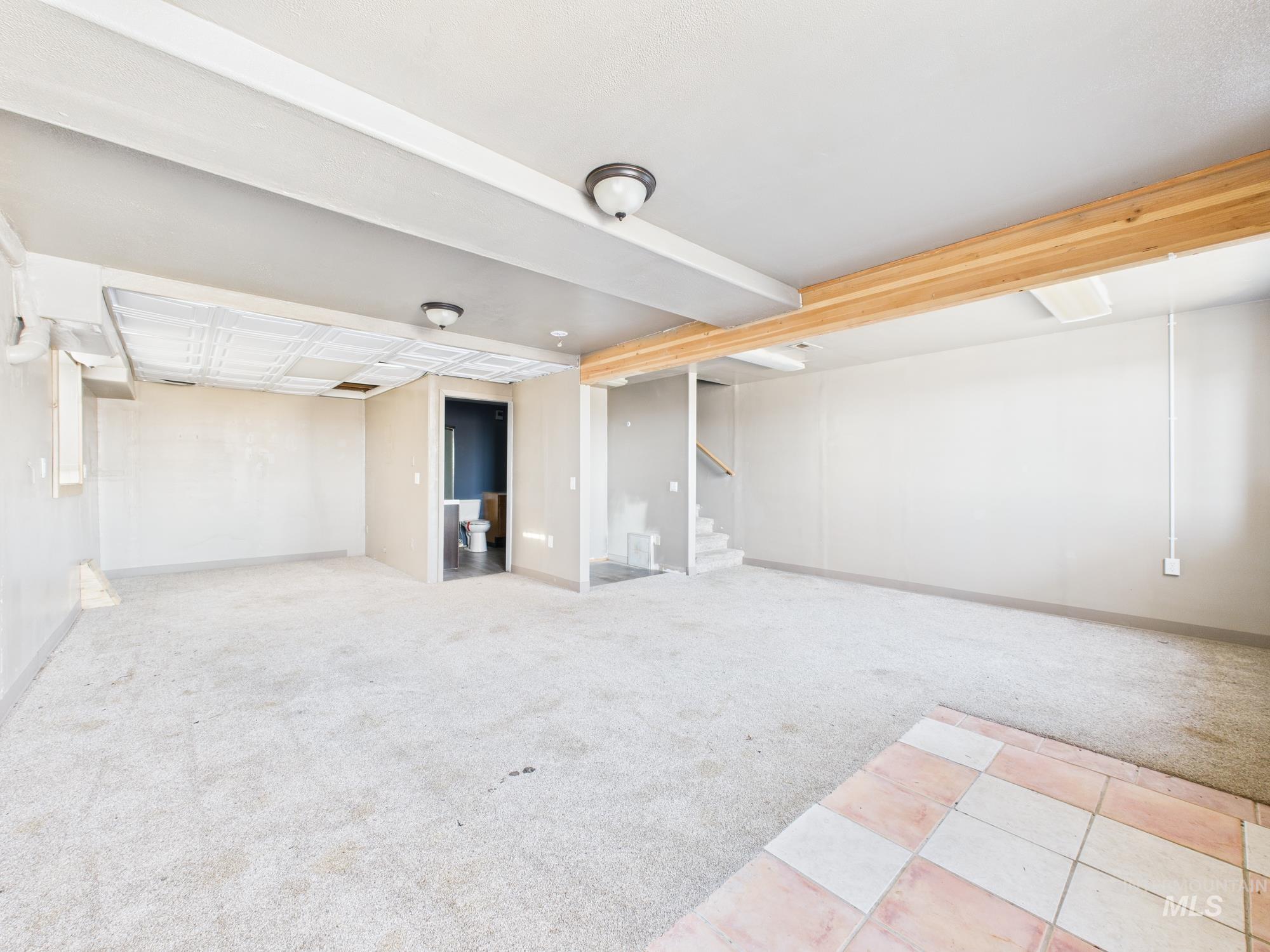 7352 Custer Road Fruitland, ID 83619 - Photo 23 of 43 Finished basement featuring light carpet and stairway