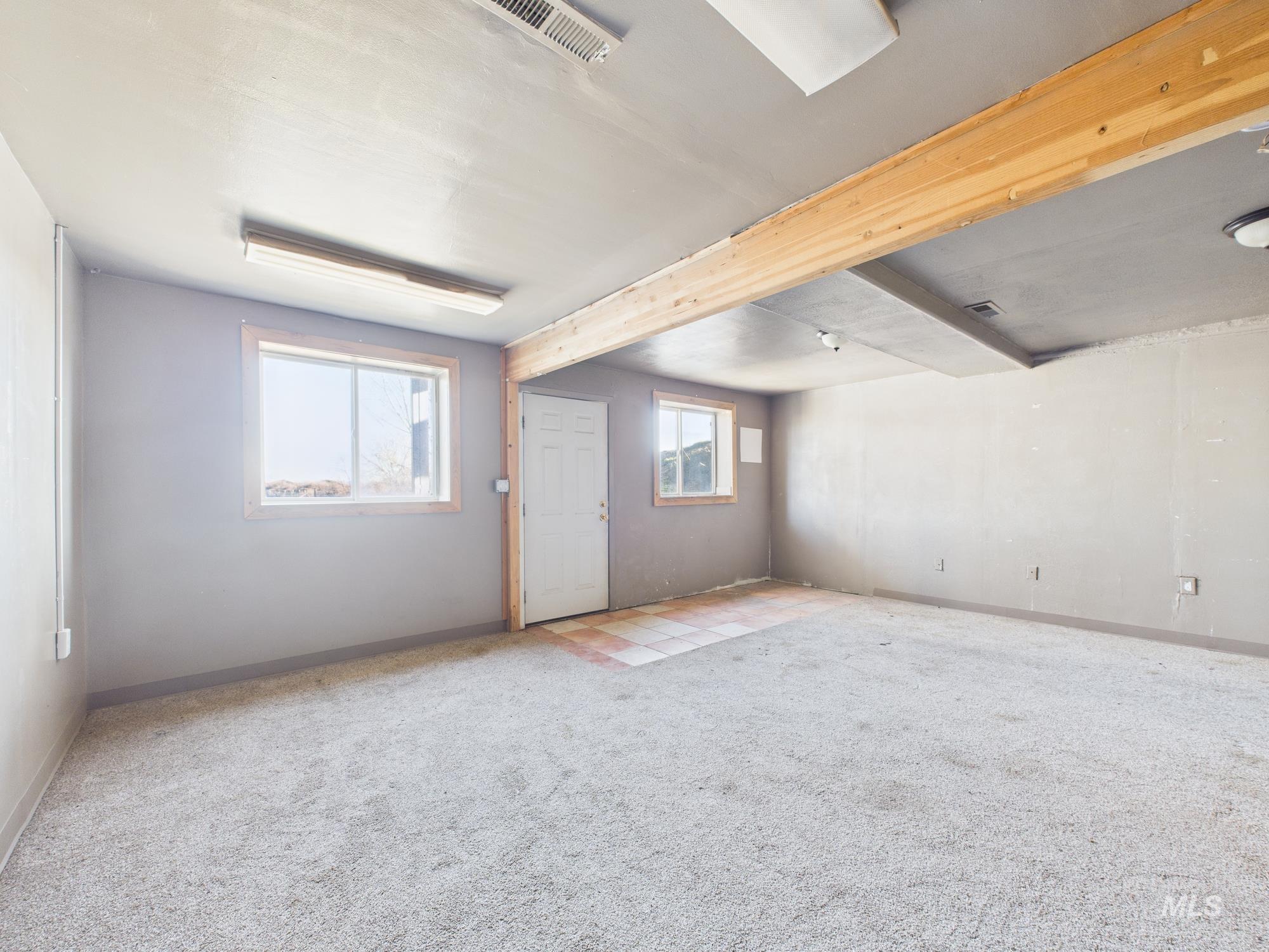 7352 Custer Road Fruitland, ID 83619 - Photo 24 of 43 Below grade area featuring light carpet and baseboards
