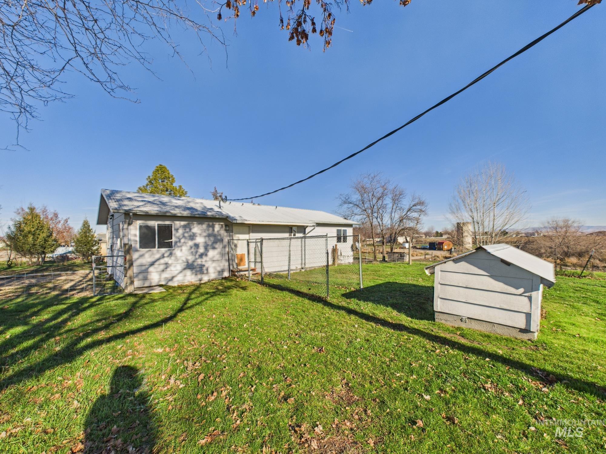 7352 Custer Road Fruitland, ID 83619 - Photo 3 of 43 Rear view of house with a storage shed