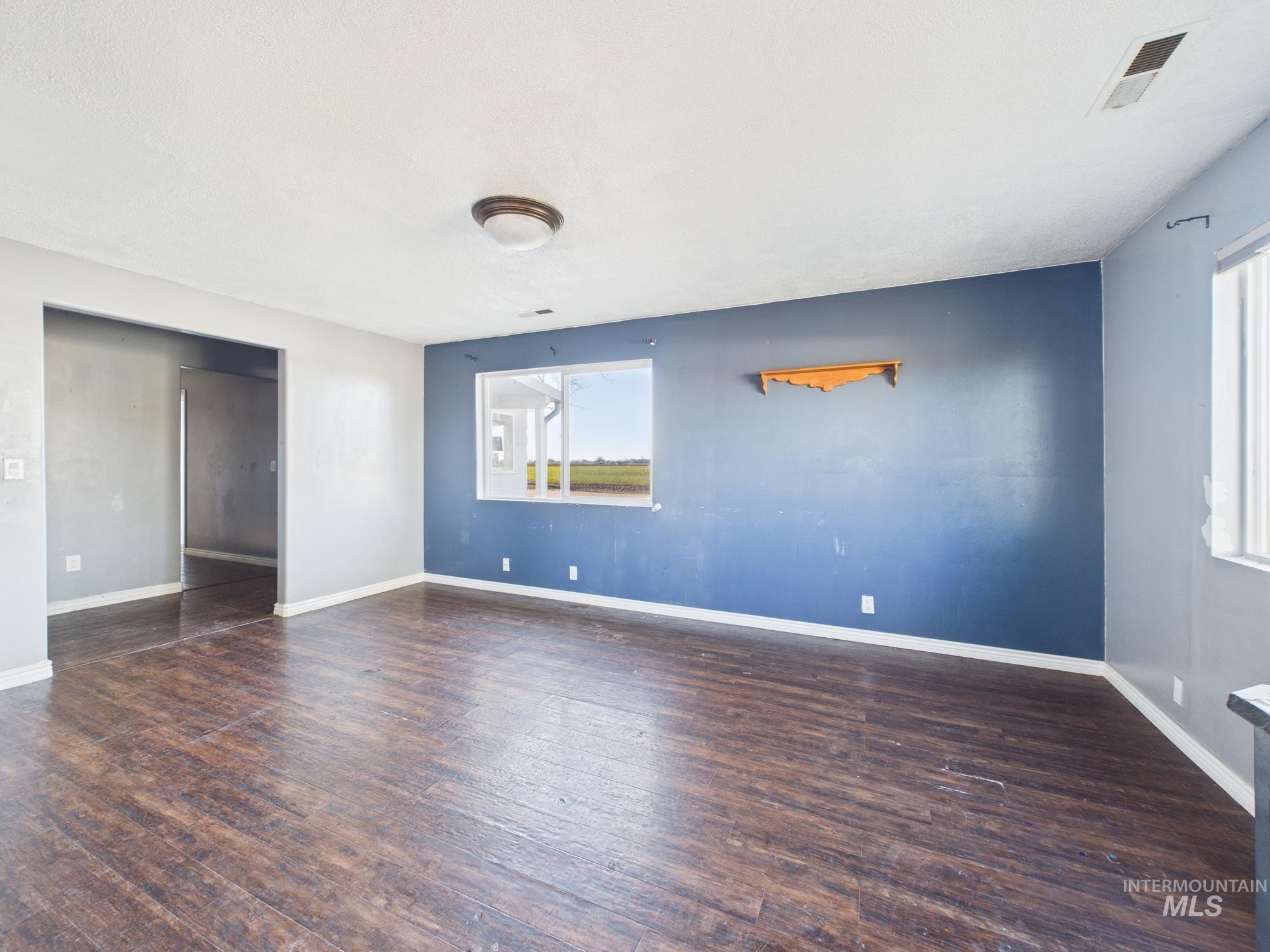 7352 Custer Road Fruitland, ID 83619 - Photo 5 of 43 Spare room featuring dark wood-style floors and baseboards