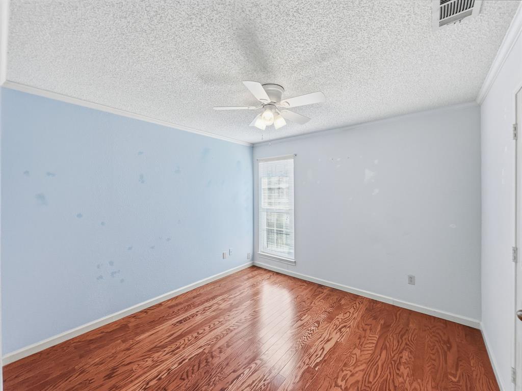 302 Apollo Road Garland, TX 75040 - Photo 18 of 38 an empty room with a window and a ceiling fan