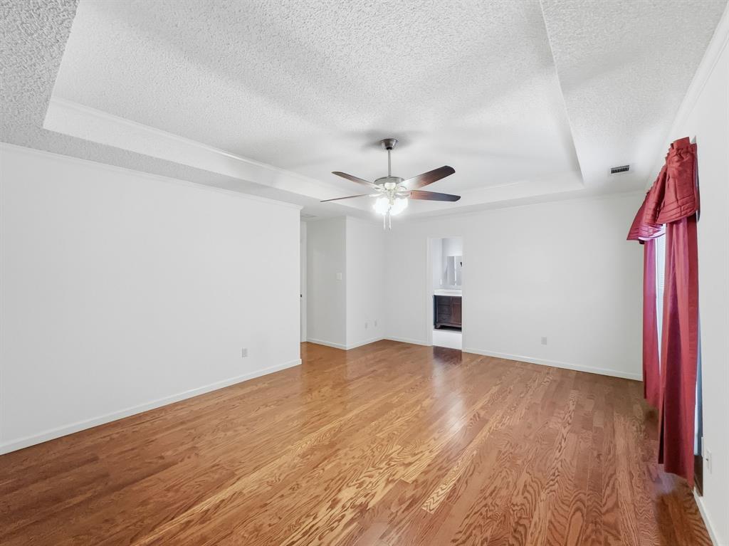 302 Apollo Road Garland, TX 75040 - Photo 22 of 38 a view of empty room with wooden floor and fan