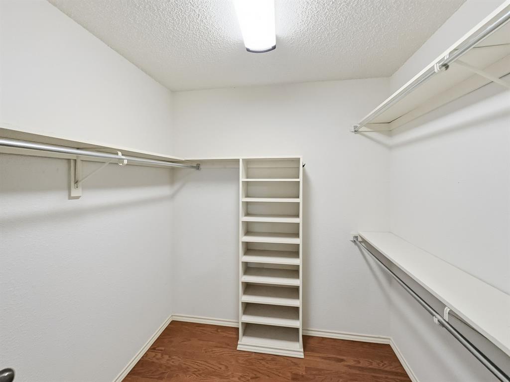 302 Apollo Road Garland, TX 75040 - Photo 23 of 38 a view of walk in closet with empty racks