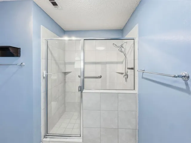 a bathroom with a glass shower door