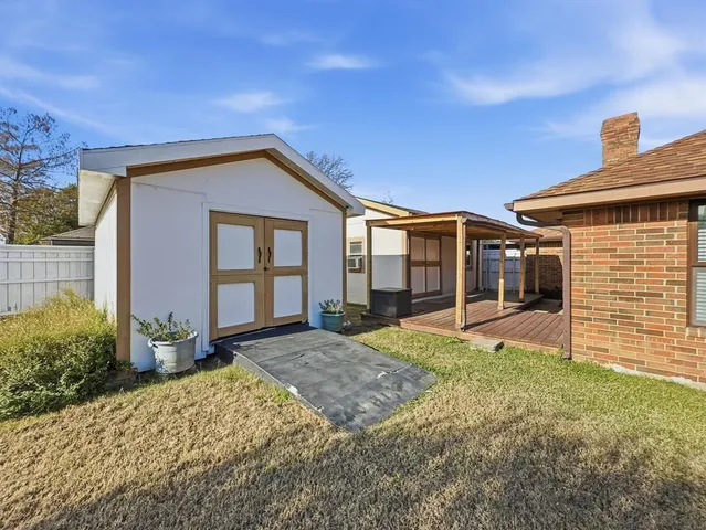a view of a patio with table and chairs