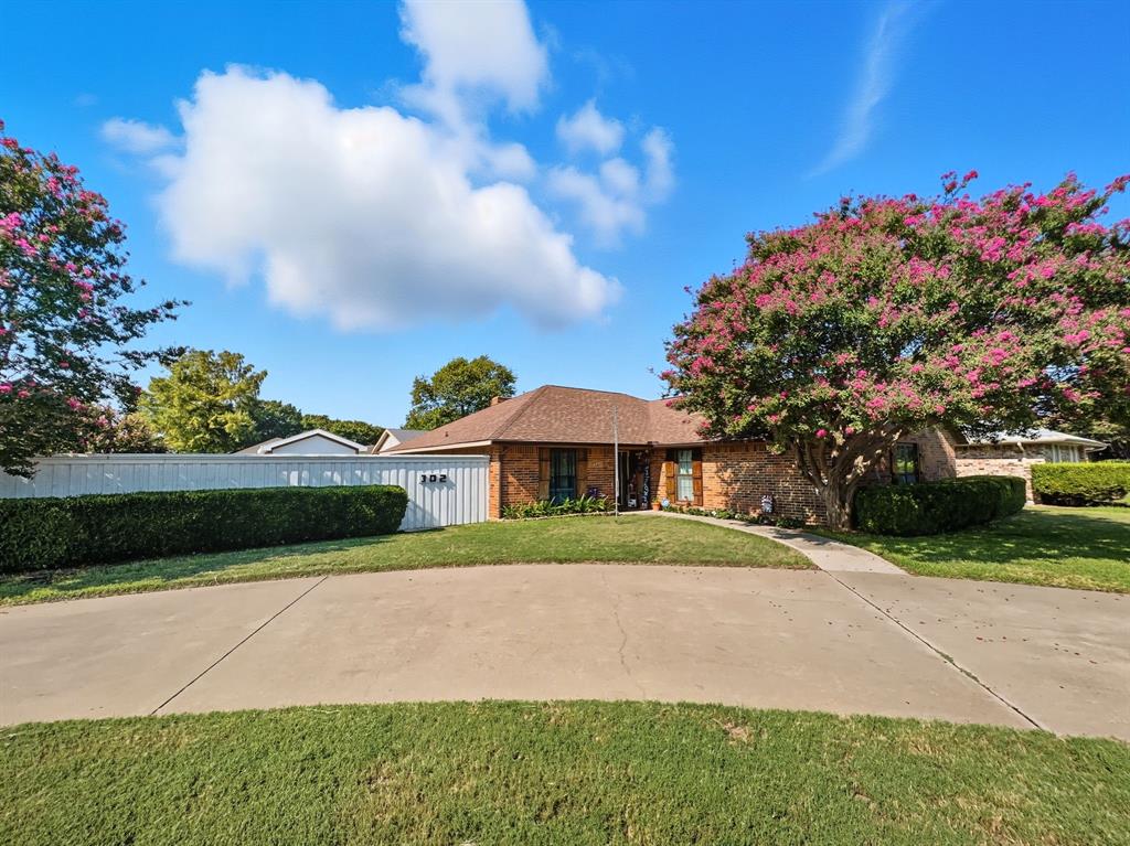 302 Apollo Road Garland, TX 75040 - Photo 37 of 38 a front view of a house with a garden