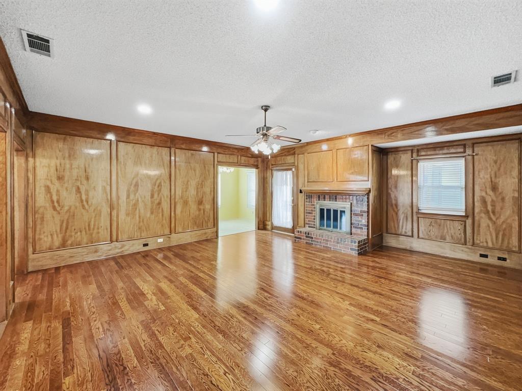 302 Apollo Road Garland, TX 75040 - Photo 4 of 38 a view of an empty room with wooden floor and a window