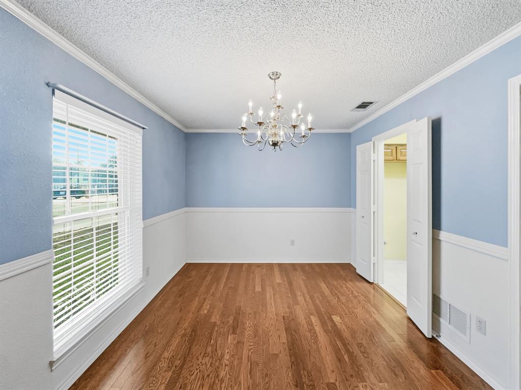 302 Apollo Road Garland, TX 75040 - Photo 5 of 38 a view of a room with wooden floor and chandelier
