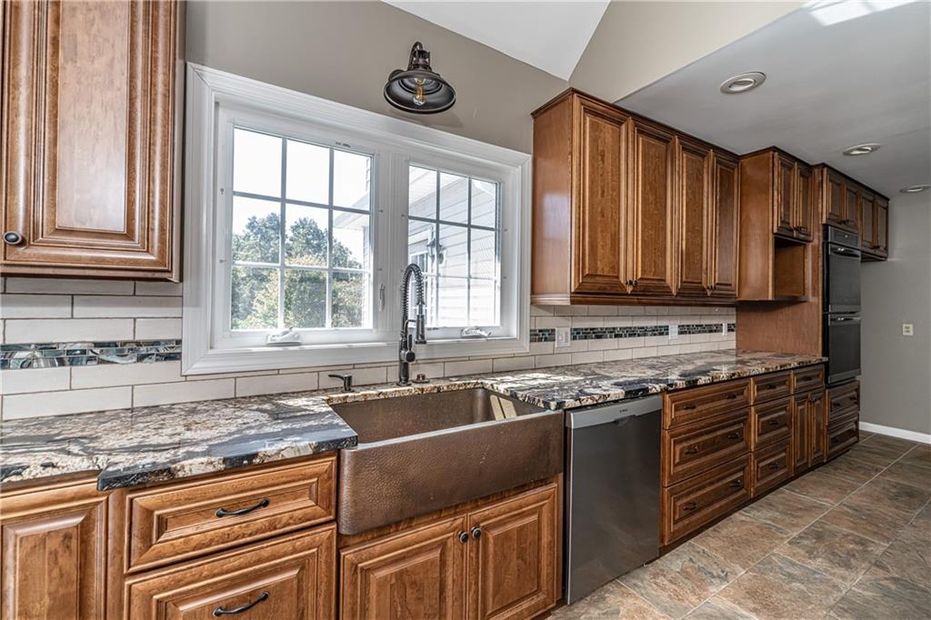 113 Warwick Way Rome, GA 30161 - Photo 13 of 49 a kitchen with stainless steel appliances granite countertop a sink stove and cabinets