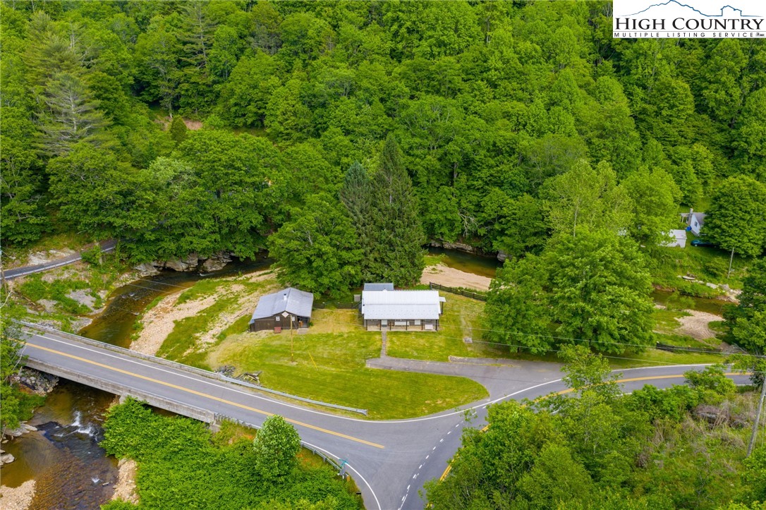 1369 Anderson Hill Road Lansing, NC 28643 - Photo 2 of 49 a view of house with swimming pool and trees in the background