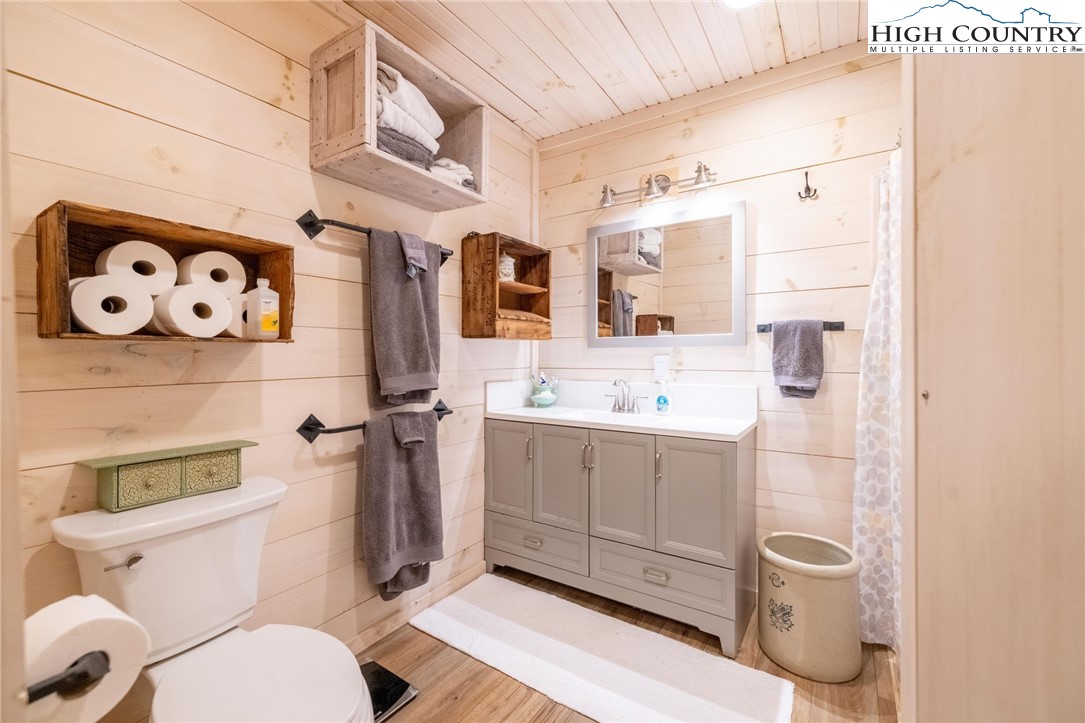 1369 Anderson Hill Road Lansing, NC 28643 - Photo 22 of 49 a bathroom with a toilet sink and mirror
