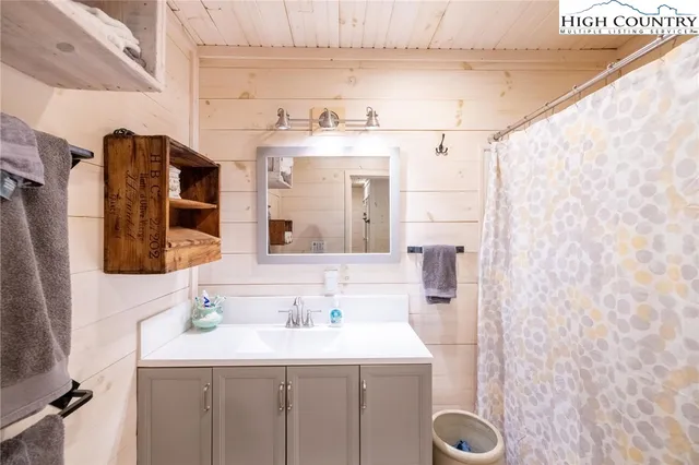 a bathroom with a sink vanity and mirror