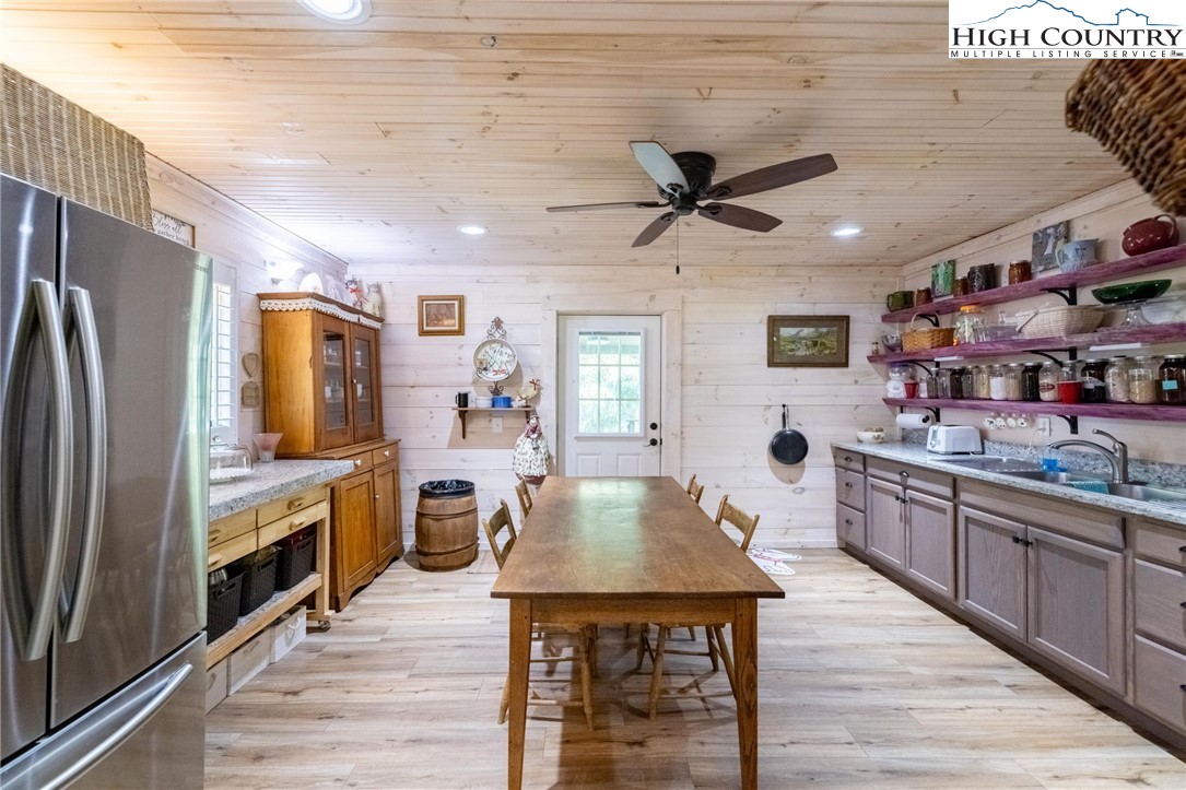 1369 Anderson Hill Road Lansing, NC 28643 - Photo 25 of 49 a large kitchen with stainless steel appliances granite countertop a lot of counter space and wooden floor