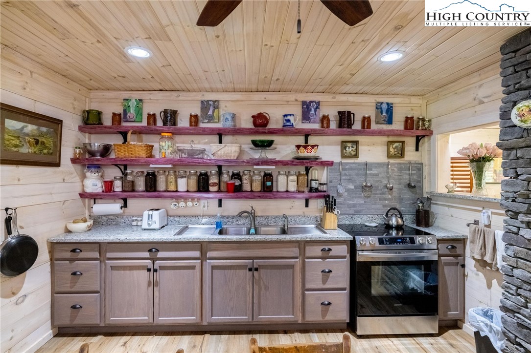 1369 Anderson Hill Road Lansing, NC 28643 - Photo 26 of 49 a kitchen with stainless steel appliances a stove and cabinets