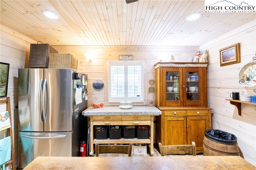 1369 Anderson Hill Road Lansing, NC 28643 - Photo 28 of 49 a kitchen with stainless steel appliances granite countertop a refrigerator and a stove top oven