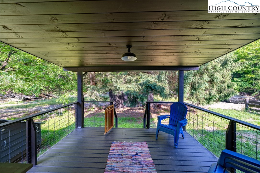 1369 Anderson Hill Road Lansing, NC 28643 - Photo 29 of 49 a view of a deck with wooden floor and outdoor seating