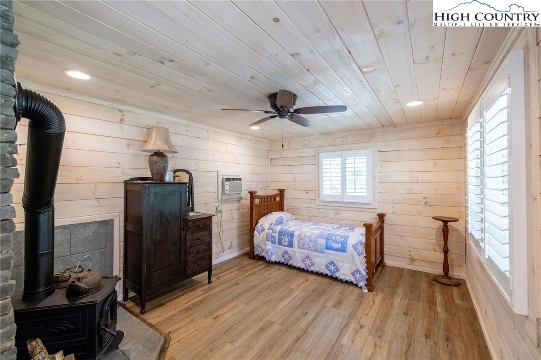 1369 Anderson Hill Road Lansing, NC 28643 - Photo 33 of 49 a bedroom with a bed and wooden floor