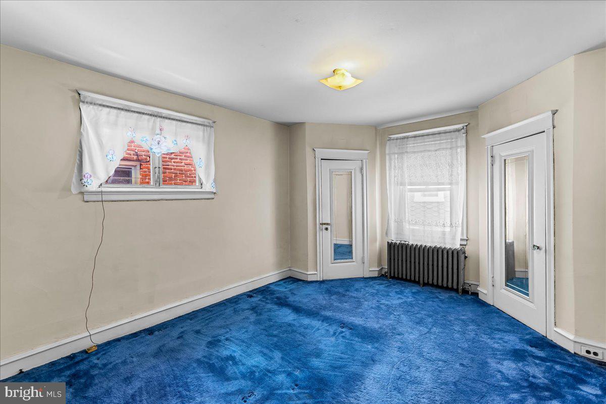 217 Avon Road Upper Darby, PA 19082 - Photo 11 of 16 an empty room with a window and wooden floor