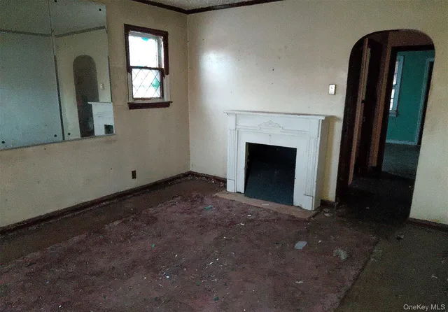 a view of empty room with windows and fireplace