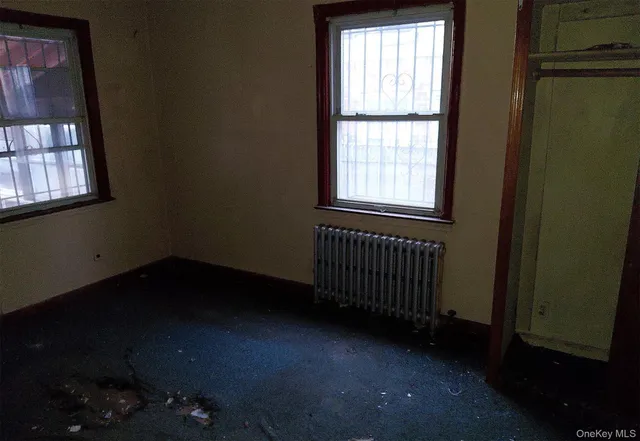 an empty room with closet and window