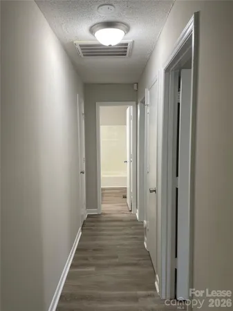 a view of a hallway with wooden floor
