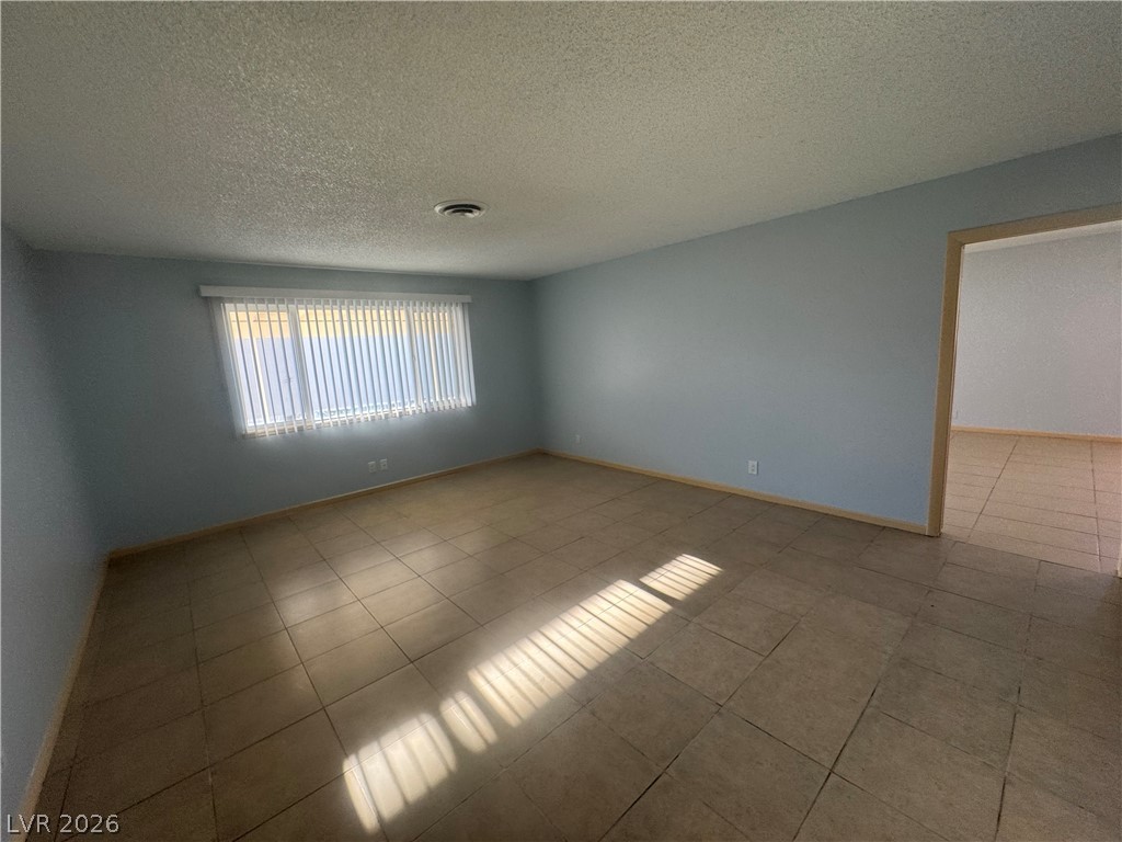 4420 Del Monte Avenue, Unit RENTAL Las Vegas, NV 89102 - Photo 10 of 20 A well-lit room offers durable tile flooring and natural light through large windows.