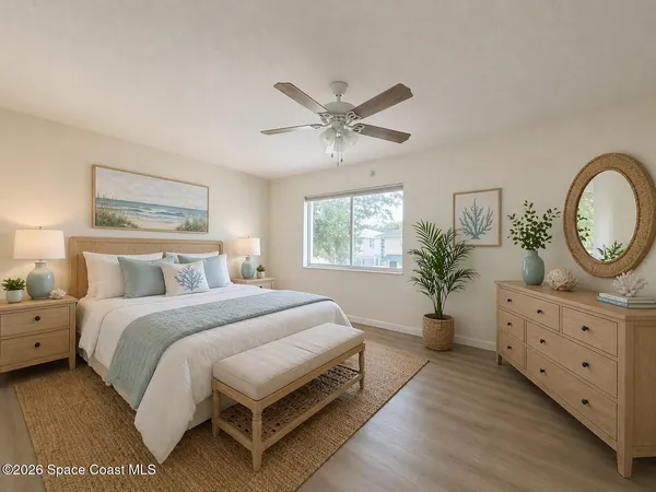 a spacious bedroom with a large bed and a chandelier