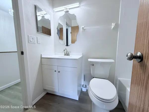 a white toilet sitting next to a bathroom sink