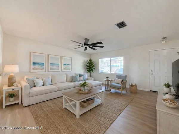 a living room with furniture and a large window