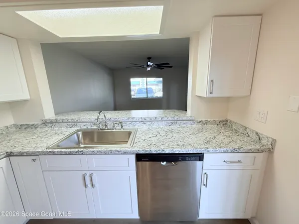 a kitchen with granite countertop a sink and a granite counter tops
