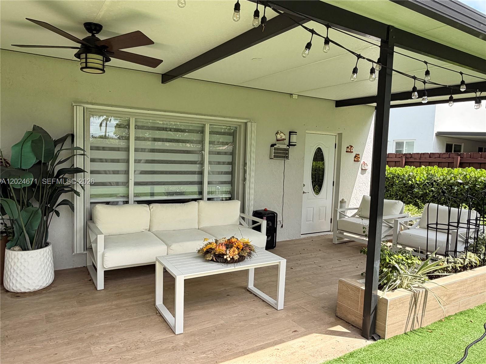 2116 Northeast 38th Road, Unit 2116 Homestead, FL 33033 - Photo 30 of 31 a living room with patio furniture and a potted plant
