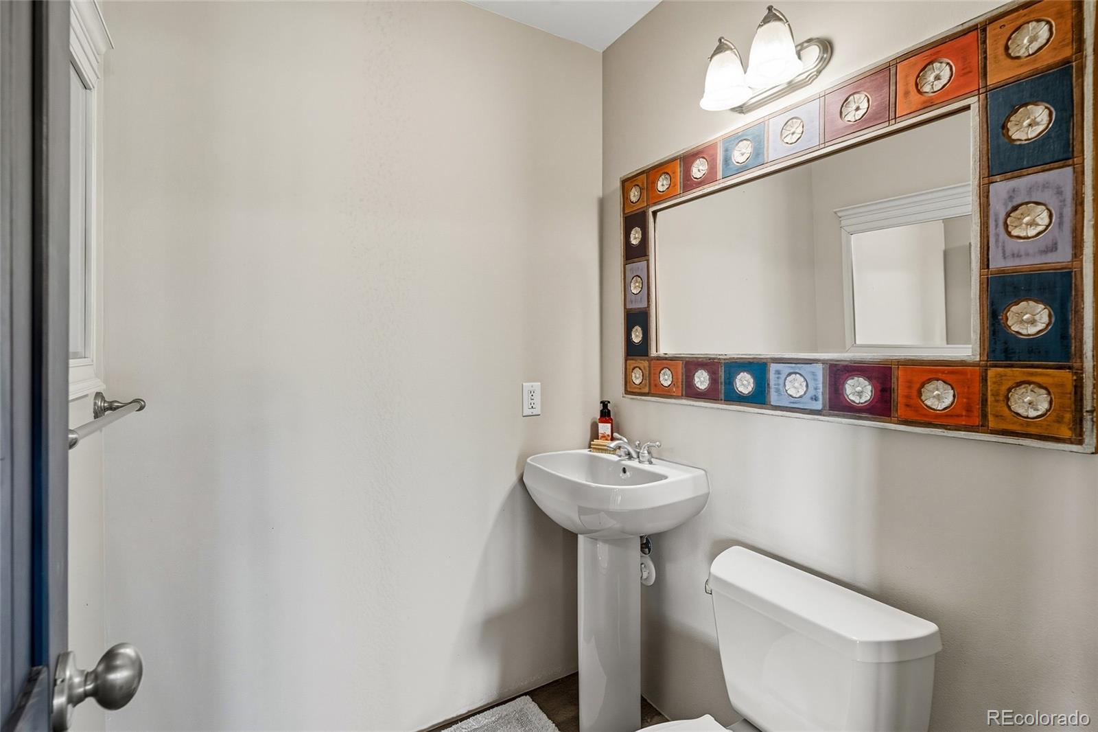 53997 County Rd LL56 Villa Grove, CO 81155 - Photo 11 of 34 a bathroom with a toilet sink and mirror