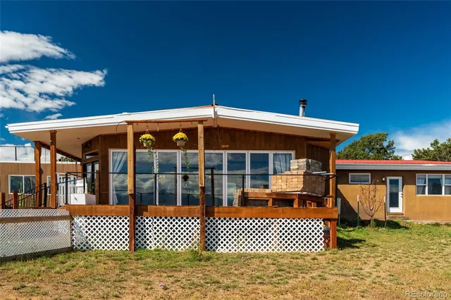 a view of house with a yard