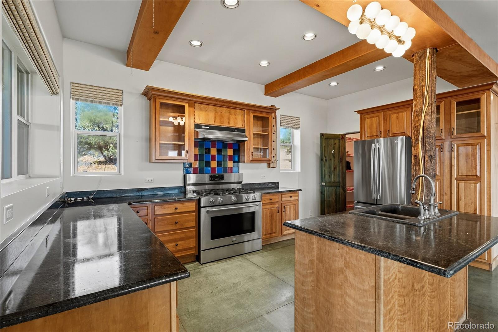 53997 County Rd LL56 Villa Grove, CO 81155 - Photo 9 of 34 a kitchen with stainless steel appliances granite countertop a sink a stove and a refrigerator