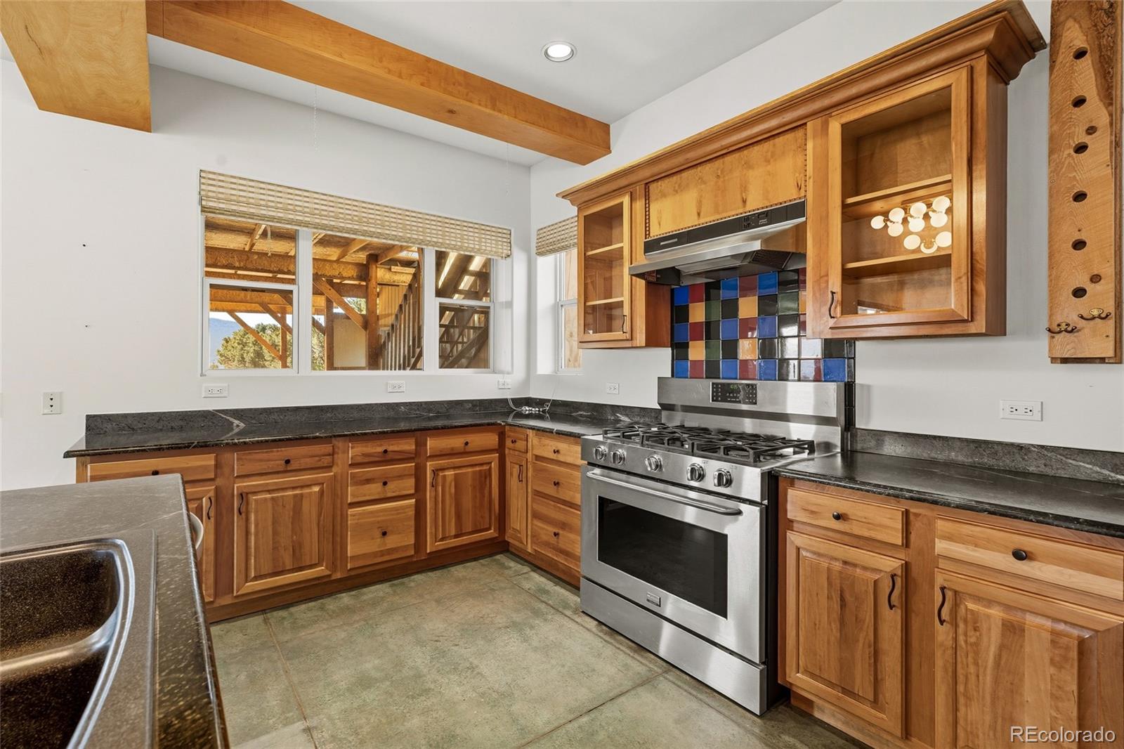 53997 County Rd LL56 Villa Grove, CO 81155 - Photo 10 of 34 a kitchen with stainless steel appliances granite countertop a stove and a sink